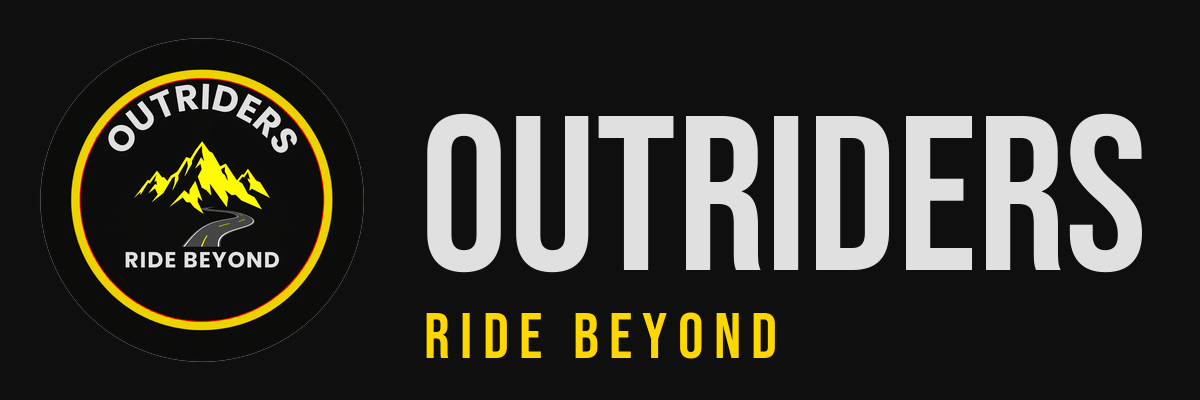 Mountain biker riding on rugged trail with mountains in background.